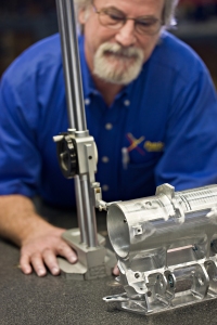 A Patriot Machine associate operating a measurement device on a recently machined part.